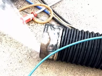 Old burst heating coil from Nilfisk Contractor pressure washer being pressure tested to find the leak.